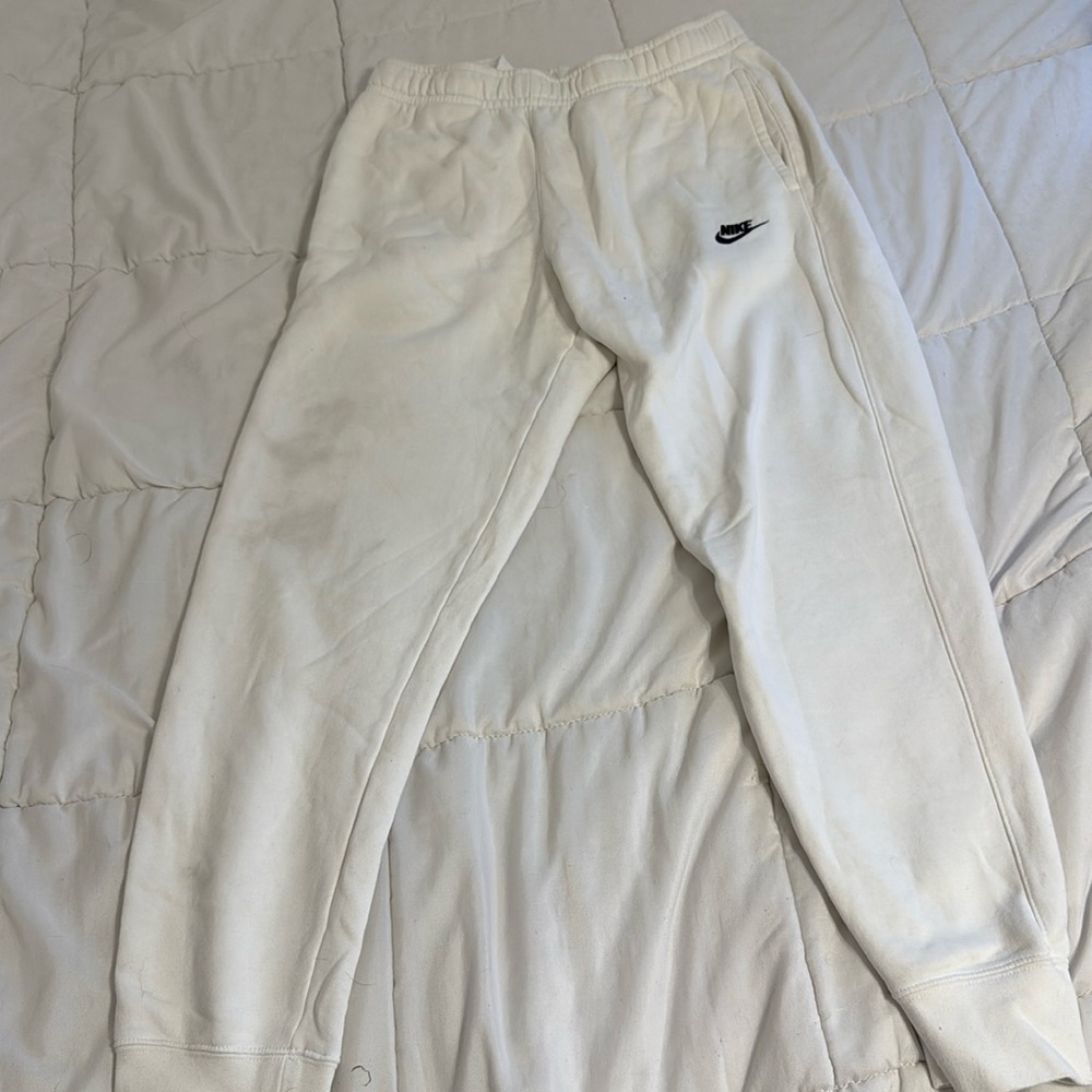 White nike sweatpants tight bottoms. Slight stain on the left leg.